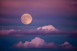 ai generado capturar lleno Luna yesos un etéreo resplandor en medio de a la deriva nubes foto