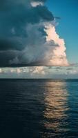 AI generated Caribbean evening sky contrasts sunlight with dark storm clouds Vertical Mobile Wallpaper photo