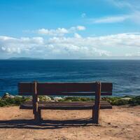 AI generated shot Wooden bench with sea view, perfect for relaxation and contemplation For Social Media Post Size photo