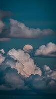 AI generated Moon peeks through billowing clouds, creating a mystical ambiance Vertical Mobile Wallpaper photo