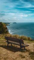 AI generated Empty bench on cliff overlooks peaceful sea, ideal for solitude Vertical Mobile Wallpaper photo