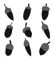 Silhouettes of different shapes of acorns and caps, isolated vector