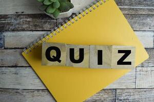 Concept of The wooden Cubes with the word Quiz on wooden background. photo