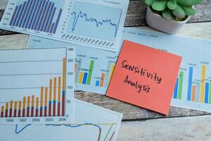 Concept of Sensitivity Analysis write on sticky notes isolated on Wooden Table. photo