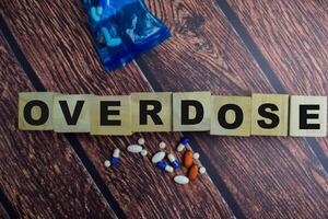 Concept of The wooden Cubes with the word Overdose on wooden background. photo