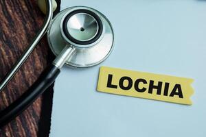 Concept of Lochia write on sticky notes with stethoscope isolated on Wooden Table. photo