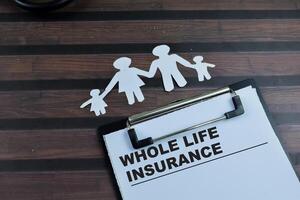 Concept of Whole Life Insurance write on paperwork isolated on wooden background. photo