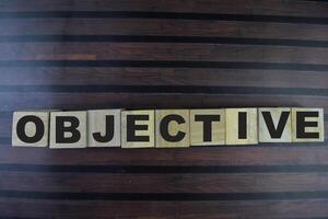 Concept of The wooden Cubes with the word Objective on wooden background. photo