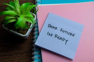 Concept of Dear Future Im Ready write on sticky notes isolated on Wooden Table. photo