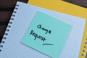 Concept of Change Request write on sticky notes isolated on Wooden Table. photo