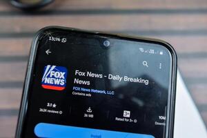 Fox News - Daily Breaking News application on Smartphone screen. Fox News is a freeware web browser developed by Fox News Network LLC. Bekasi, Indonesia, March 24, 2024 photo