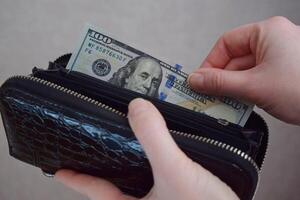 Female taking out euro money from her pocket wallet. Earnings, saving, economy concept photo