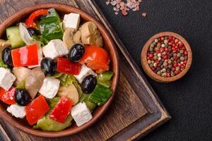 Delicious fresh juicy salad of sweet peppers, cheese, olives, tomatoes, cucumbers photo