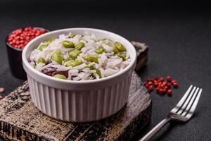 Delicious white cooked rice with green edamame beans with salt and spices photo