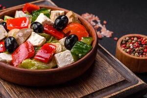 Delicious fresh juicy salad of sweet peppers, cheese, olives, tomatoes, cucumbers photo