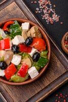 Delicious fresh juicy salad of sweet peppers, cheese, olives, tomatoes, cucumbers photo