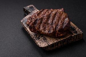 Fresh juicy delicious beef steak on a dark background photo