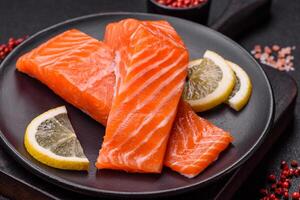 Fresh raw salmon steak with spices and herbs prepared for grilled baking photo