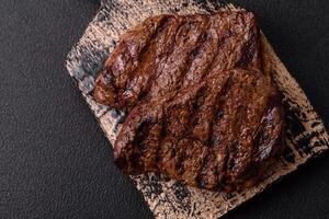 Fresh juicy delicious beef steak on a dark background photo