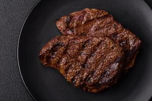 Fresh juicy delicious beef steak on a dark background photo