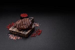 Fresh juicy delicious beef steak on a dark background photo