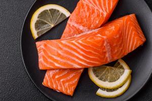 Fresh raw salmon steak with spices and herbs prepared for grilled baking photo