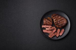 Fresh juicy delicious beef steak on a dark background photo