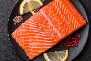 Fresh raw salmon steak with spices and herbs prepared for grilled baking photo