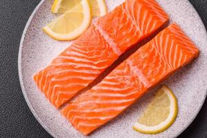 Fresh raw salmon steak with spices and herbs prepared for grilled baking photo