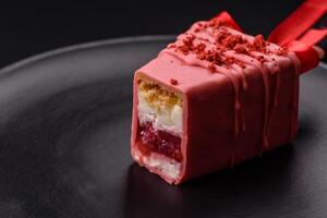 Delicious sweet cheesecake with fruits covered with icing with a wooden stick photo