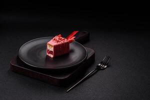 Delicious sweet cheesecake with fruits covered with icing with a wooden stick photo