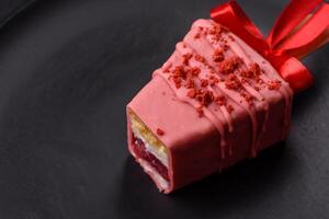 Delicious sweet cheesecake with fruits covered with icing with a wooden stick photo