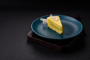 Delicious sweet cheesecake with fruits covered with icing with a wooden stick photo