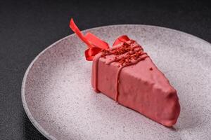 Delicious sweet cheesecake with fruits covered with icing with a wooden stick photo