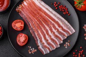 Fresh raw bacon sliced with spices and herbs photo