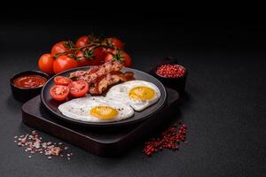 English breakfast with fried eggs, bacon, beans, tomatoes, spices and herbs photo