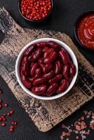 Canned red beans with salt and spices in a white bowl photo