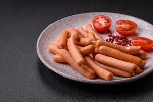 Delicious fresh small vegetarian sausages with salt, spices and herbs photo