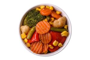 Delicious healthy vegetables steamed carrots, broccoli, asparagus beans and peppers photo