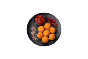 Delicious  balls of mozzarella and parmesan cheese with salt and spices photo