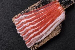 Fresh raw bacon sliced with spices and herbs photo