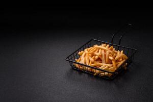 Delicious crispy golden fries with salt and spices photo