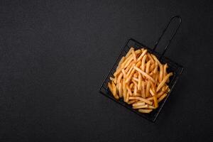 Delicious crispy golden fries with salt and spices photo