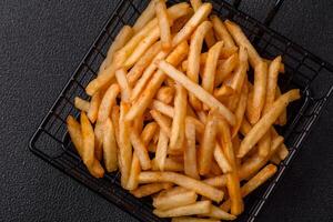 Delicious crispy golden fries with salt and spices photo