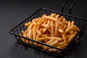 Delicious crispy golden fries with salt and spices photo