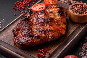 Fresh juicy delicious beef steak on a dark background photo