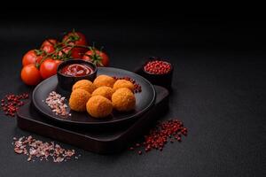 Delicious  balls of mozzarella and parmesan cheese with salt and spices photo