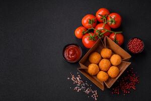 Delicious  balls of mozzarella and parmesan cheese with salt and spices photo