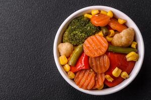 Delicious healthy vegetables steamed carrots, broccoli, asparagus beans and peppers photo