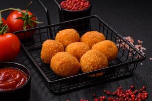 Delicious  balls of mozzarella and parmesan cheese with salt and spices photo